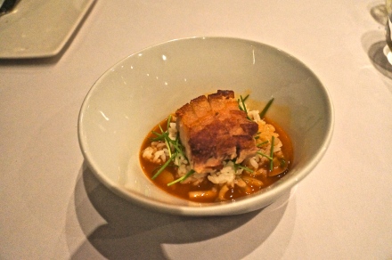 Pork belly over rice with a spicy broth.